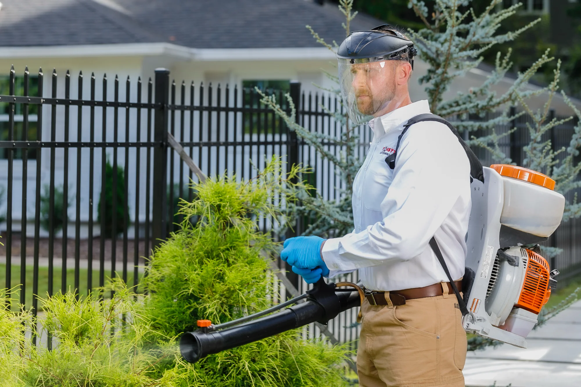 Forsyth Exterminating technician performing a pest control treatment in Cumming, GA